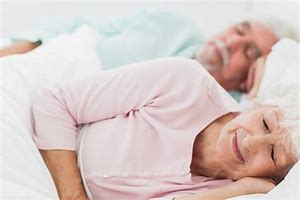 Benefits of side sleeping elderly couple